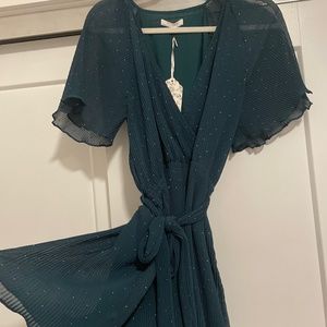 Dark green play suit with tag